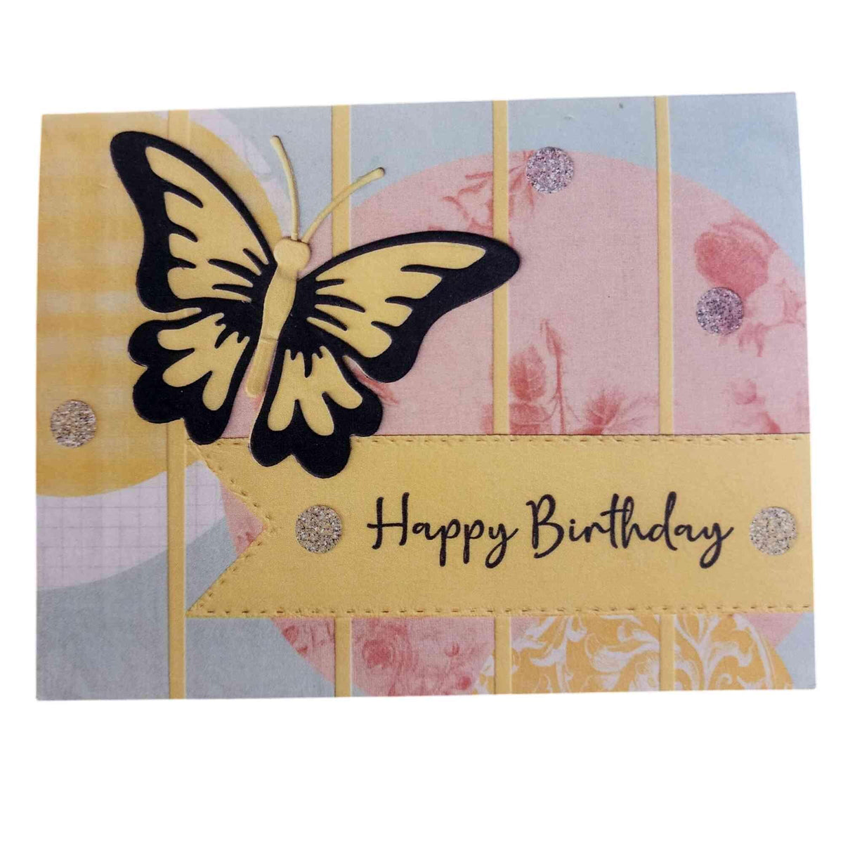 A handmade-style square birthday card featuring a large yellow and black butterfly on the left, a pale yellow banner across the middle with the words 'Happy Birthday' in black script, and a multicolor patterned background with pastel stripes and floral motifs.